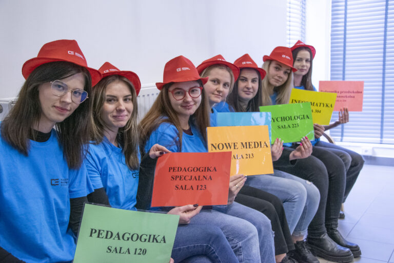 Studentki trzymające kartki z nazwami kierunków